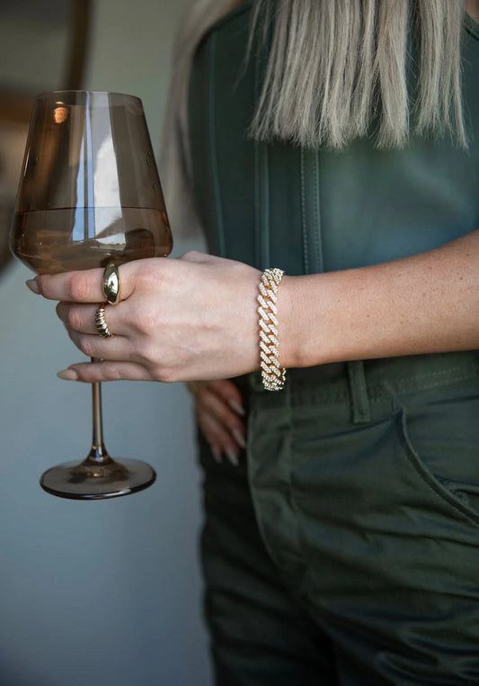 a close up of a person holding a wine glass