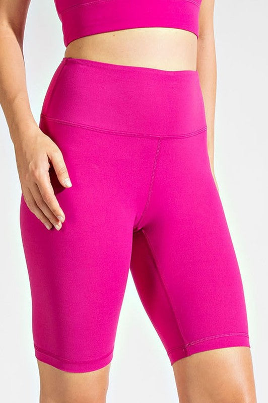 a woman in a pink sports bra top and shorts