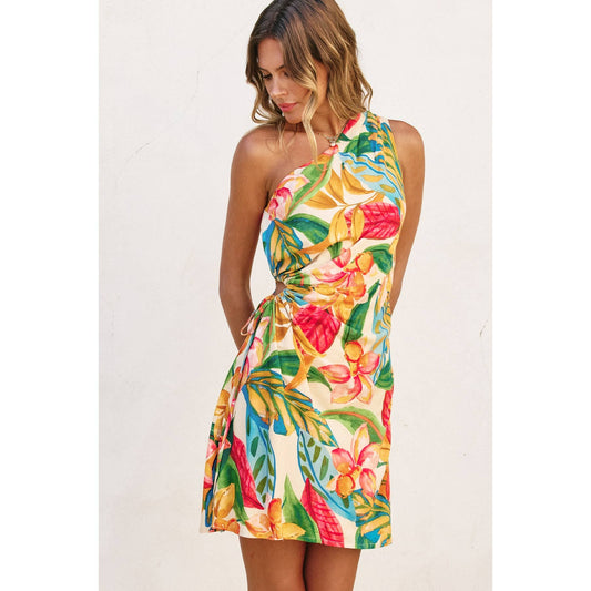 A woman wearing a floral print one-shoulder mini dress with ruching details and a keyhole drawstring at the side.