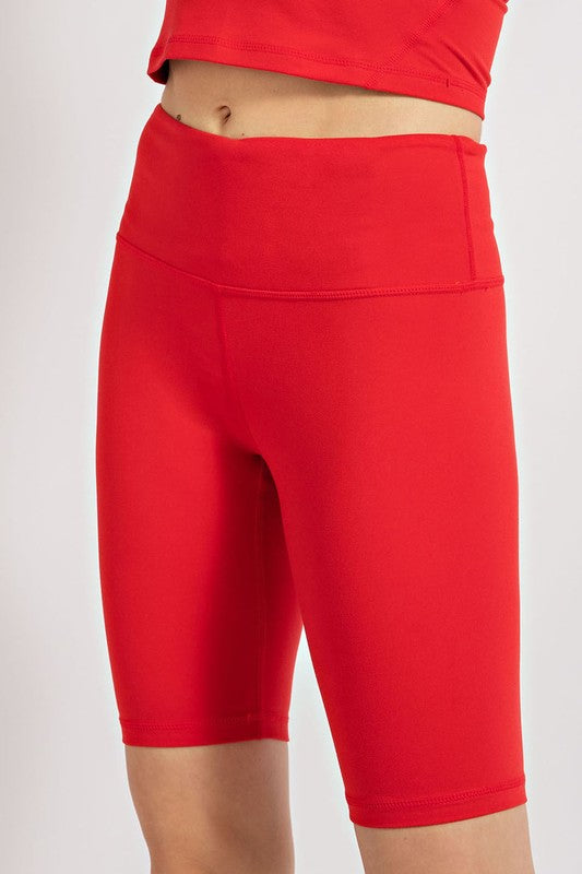 a close up of a person wearing red shorts