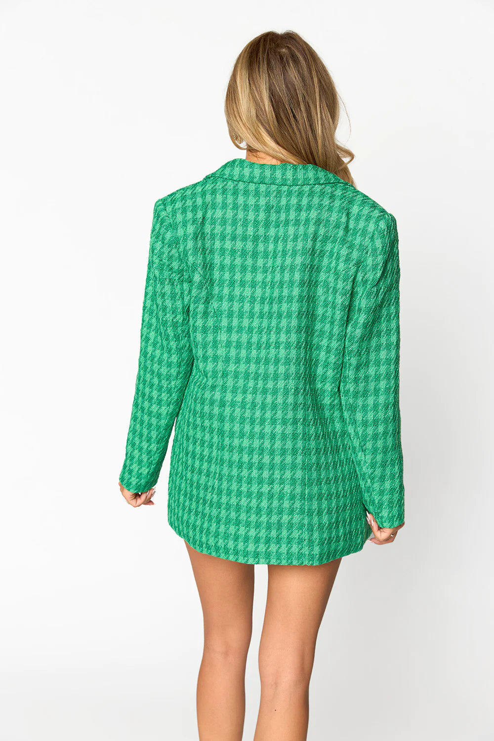 a woman in a green checkered blazer and shorts