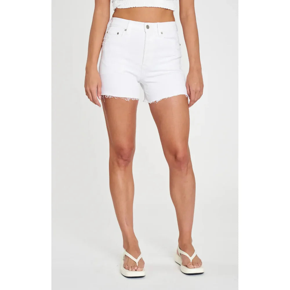a woman wearing white shorts and a crop top