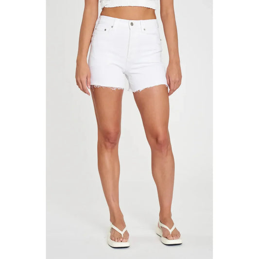 a woman wearing white shorts and a crop top