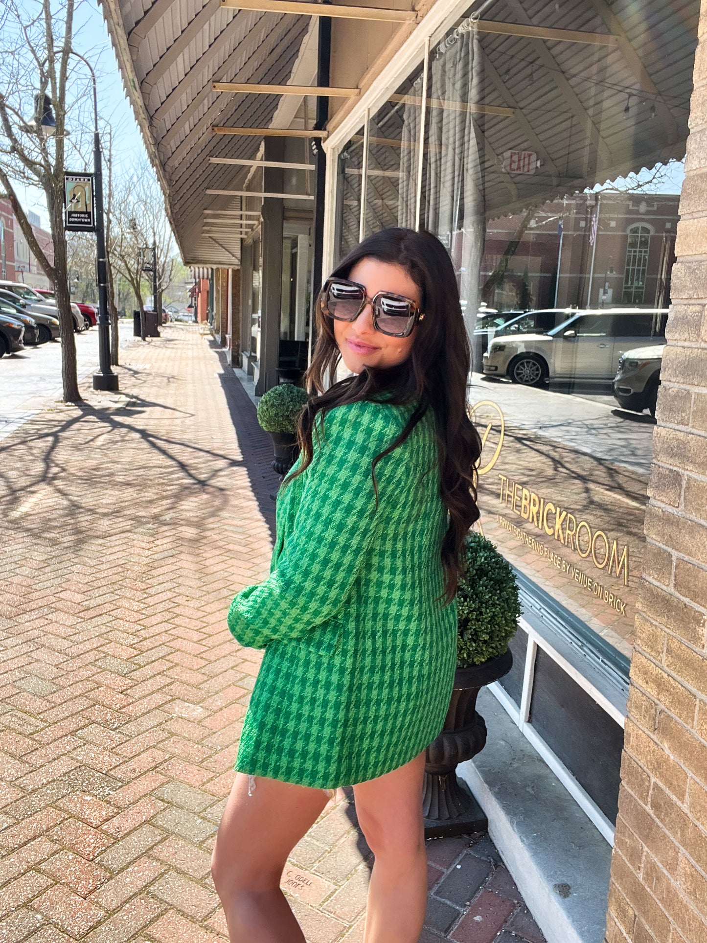 a woman in a green dress posing for a picture