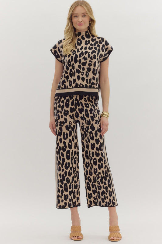 Woman wearing a leopard print outfit on a white background