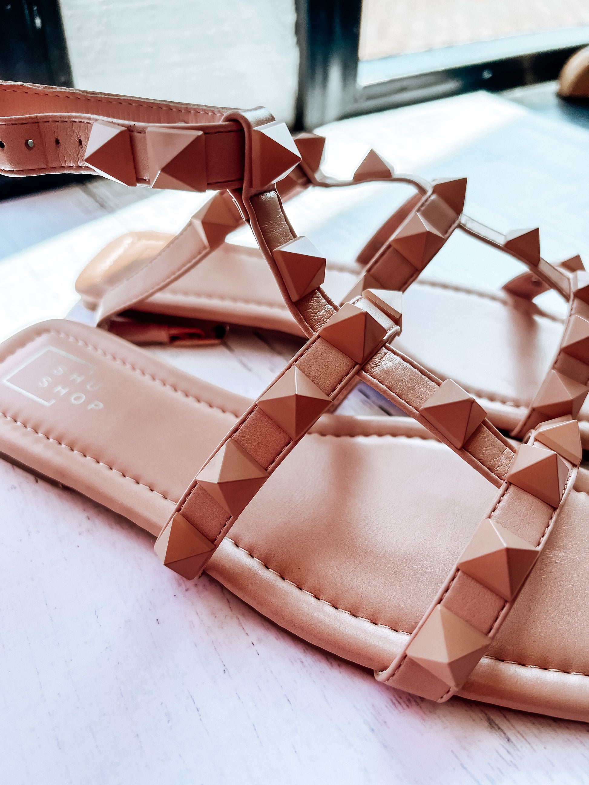 a pair of pink sandals sitting on top of a table