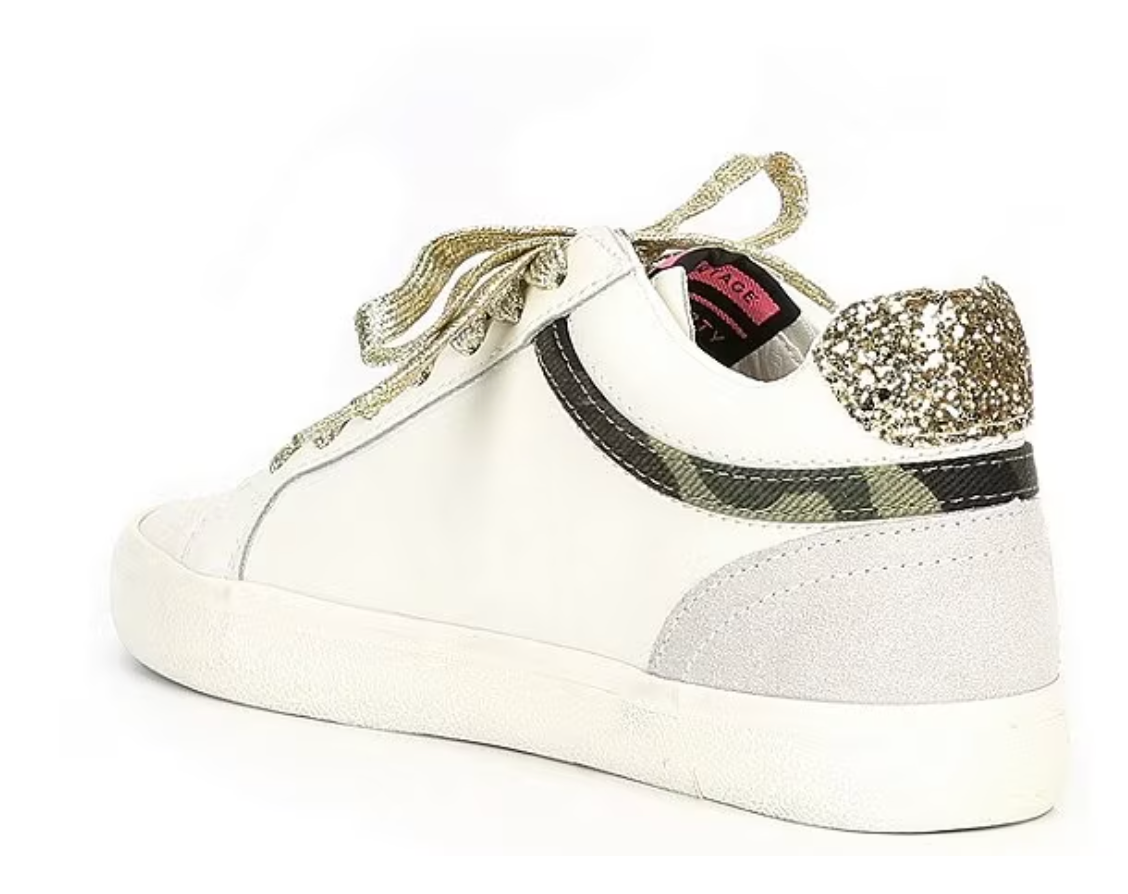 a white sneaker with gold sequins on the side