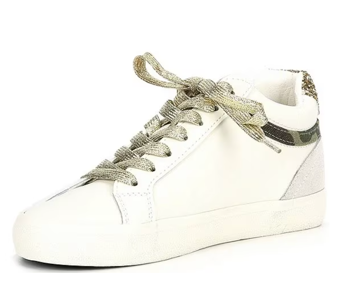 a white sneaker with a metallic lace on the top
