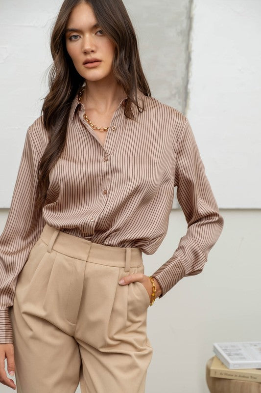 a woman standing in front of a white wall