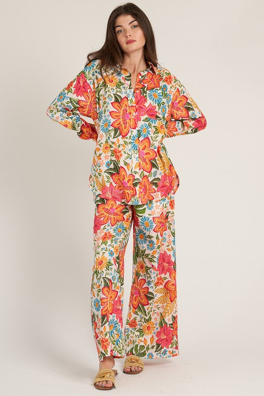 a woman in a colorful floral print jumpsuit