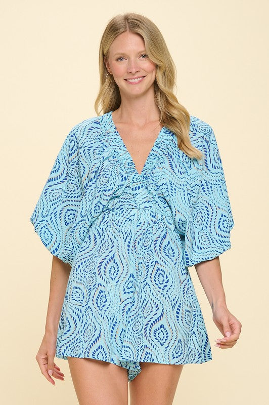 a woman in a blue and white patterned romper