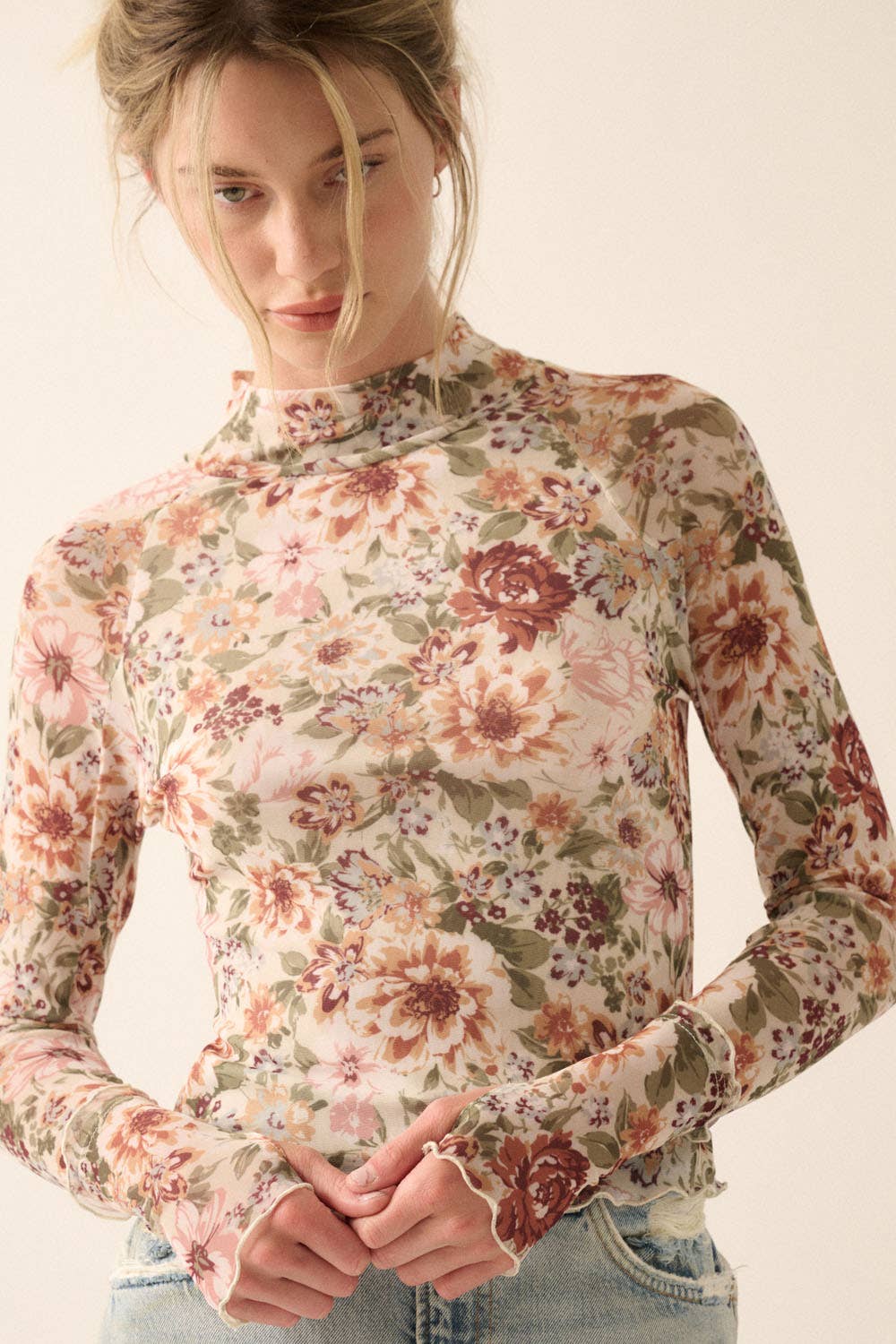 a woman in a floral shirt is posing for a picture