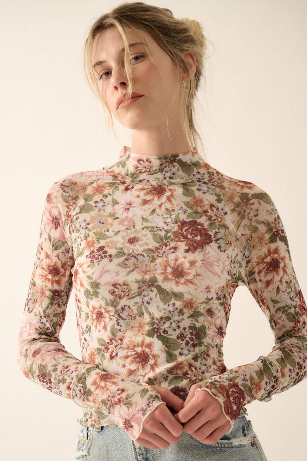 a woman in a floral shirt is posing for a picture