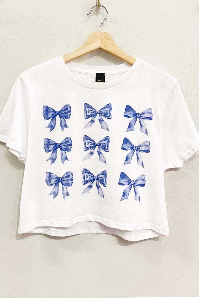 a white shirt with blue bows on it