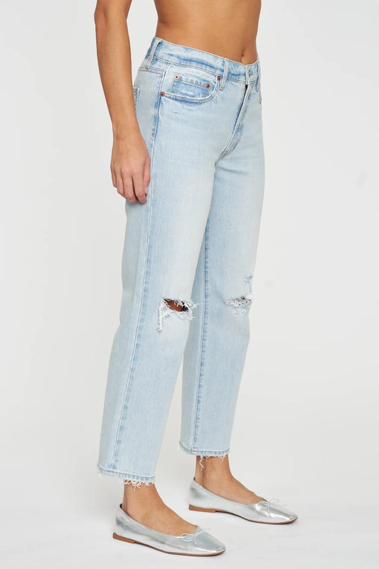 a woman wearing a pair of ripped jeans