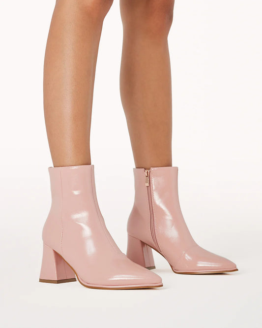 a close up of a woman's legs wearing pink boots