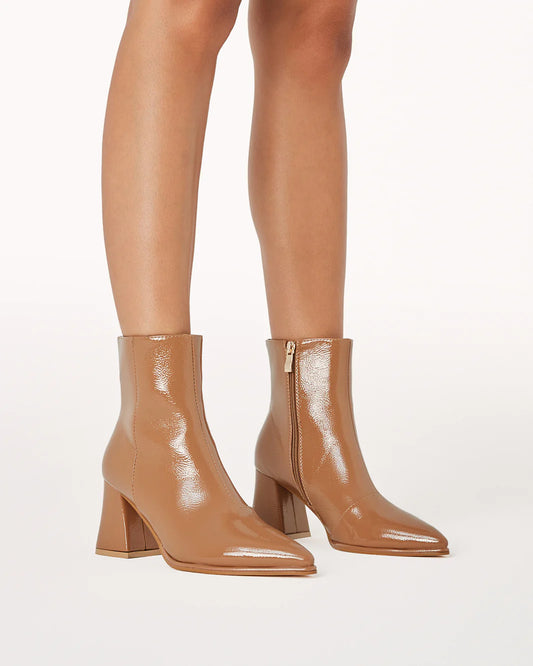 a close up of a person wearing high heel boots