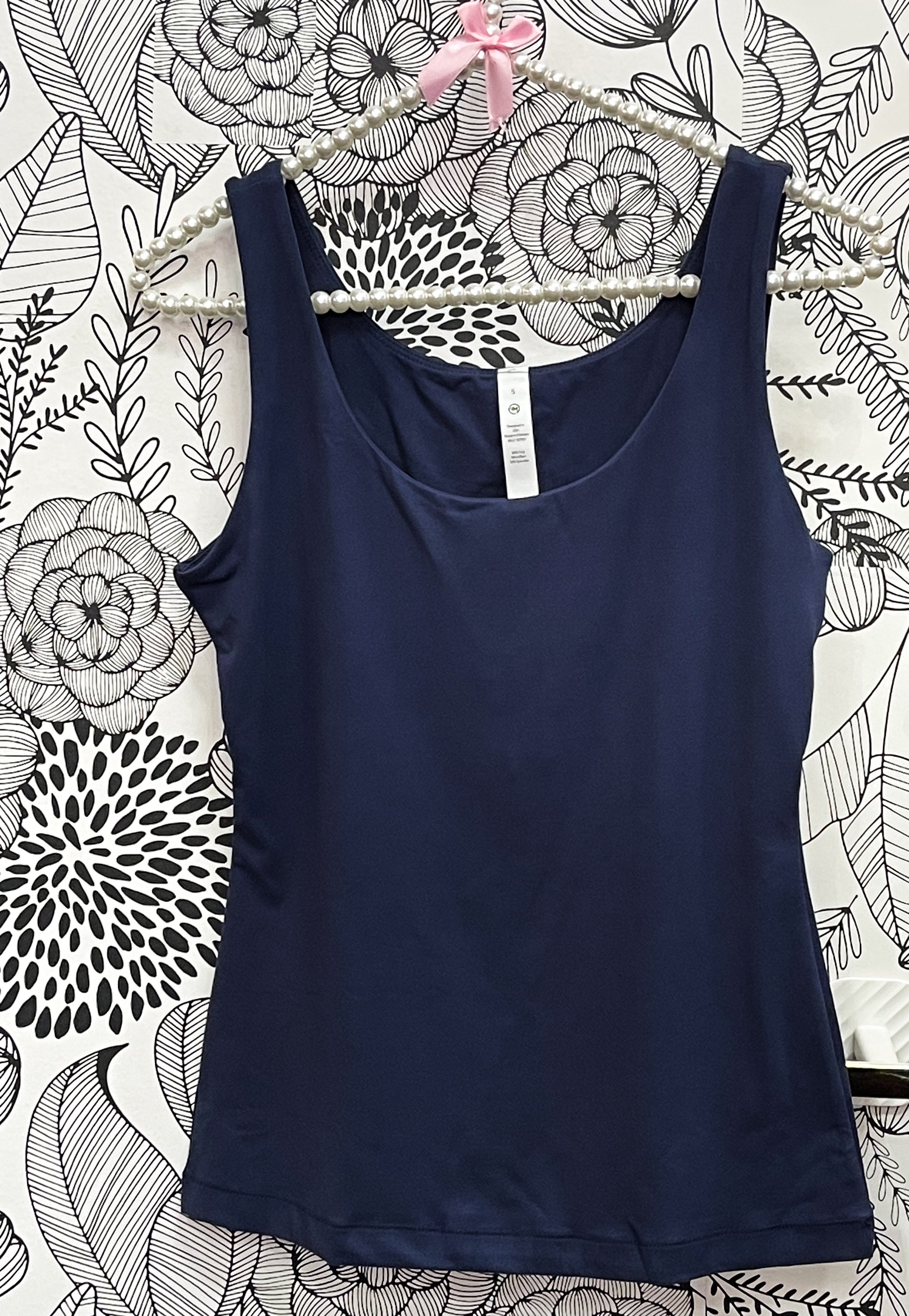 a blue tank top hanging on a wall