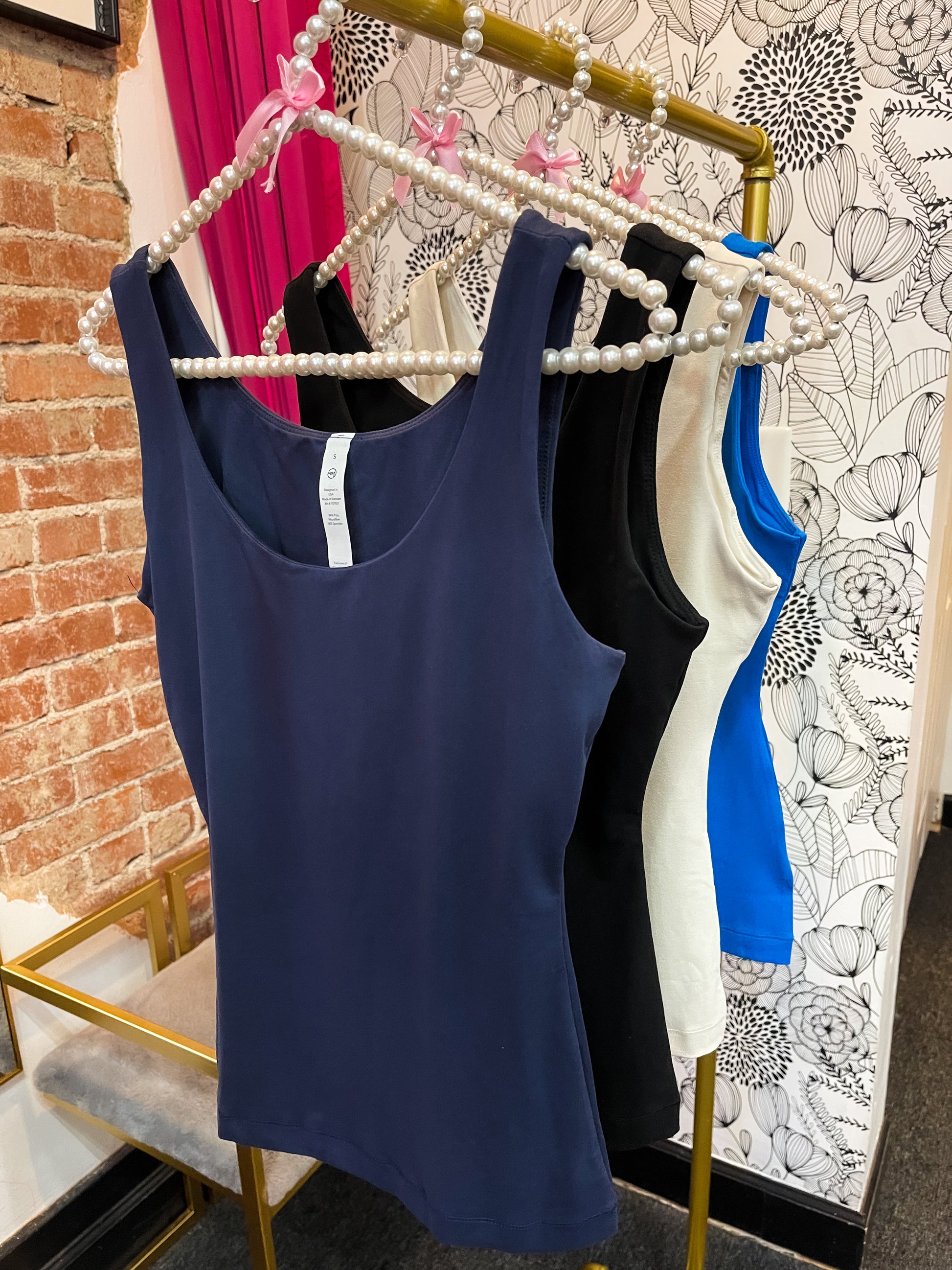 a rack of women's tank tops in a store