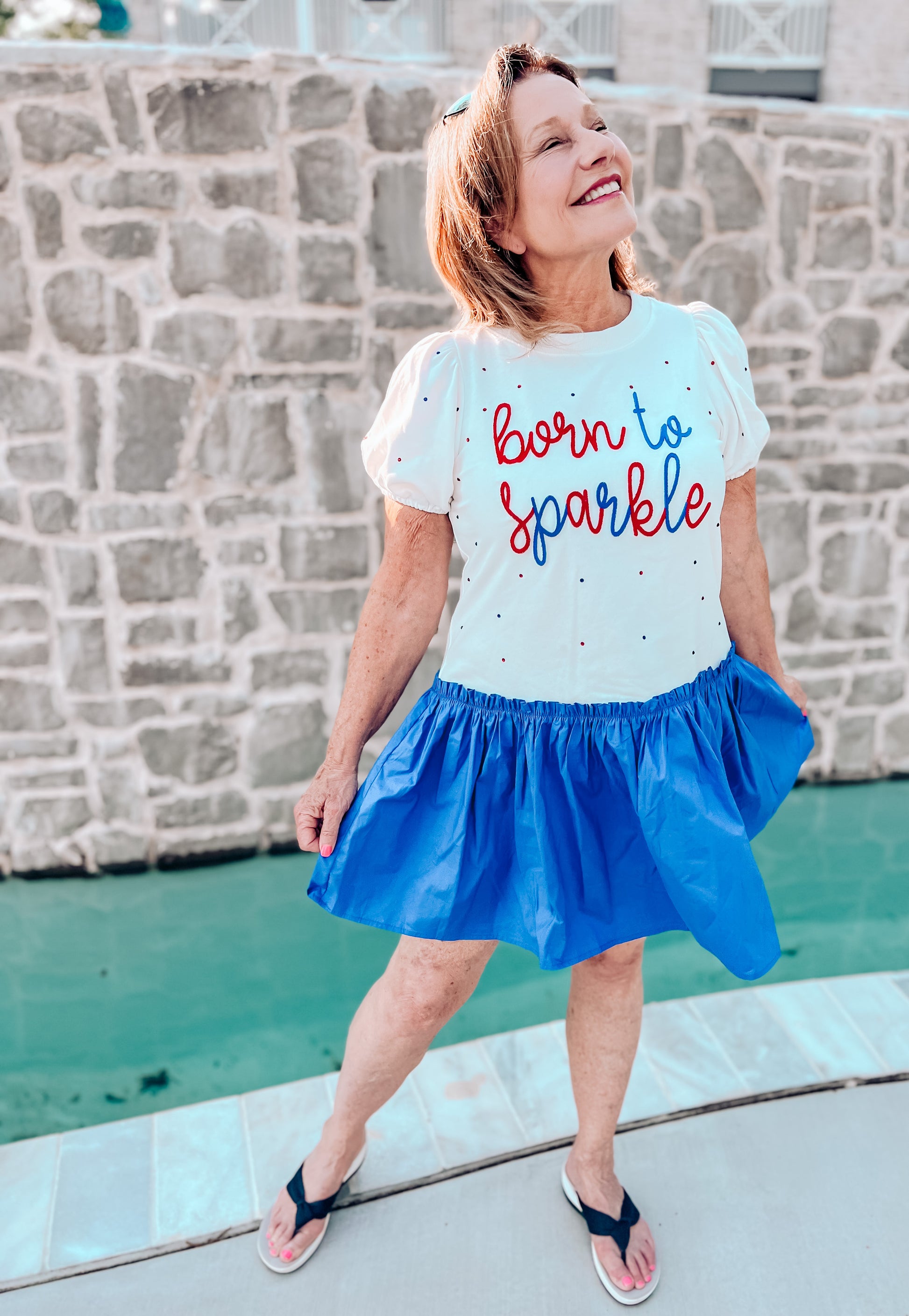 a little girl that is wearing a shirt that says born to sparkle