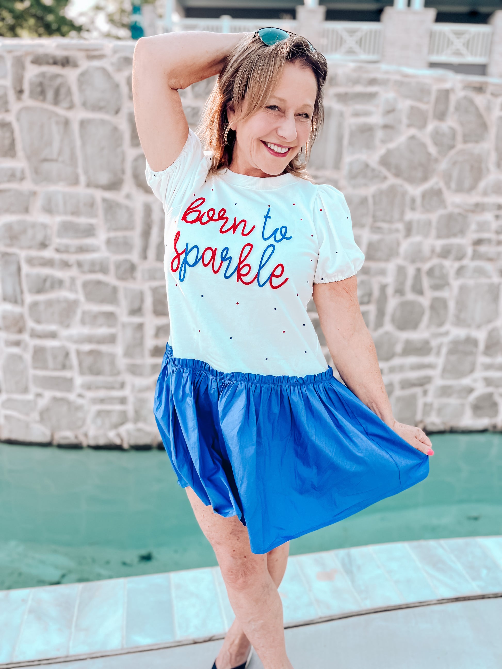 a woman in a white shirt and blue skirt