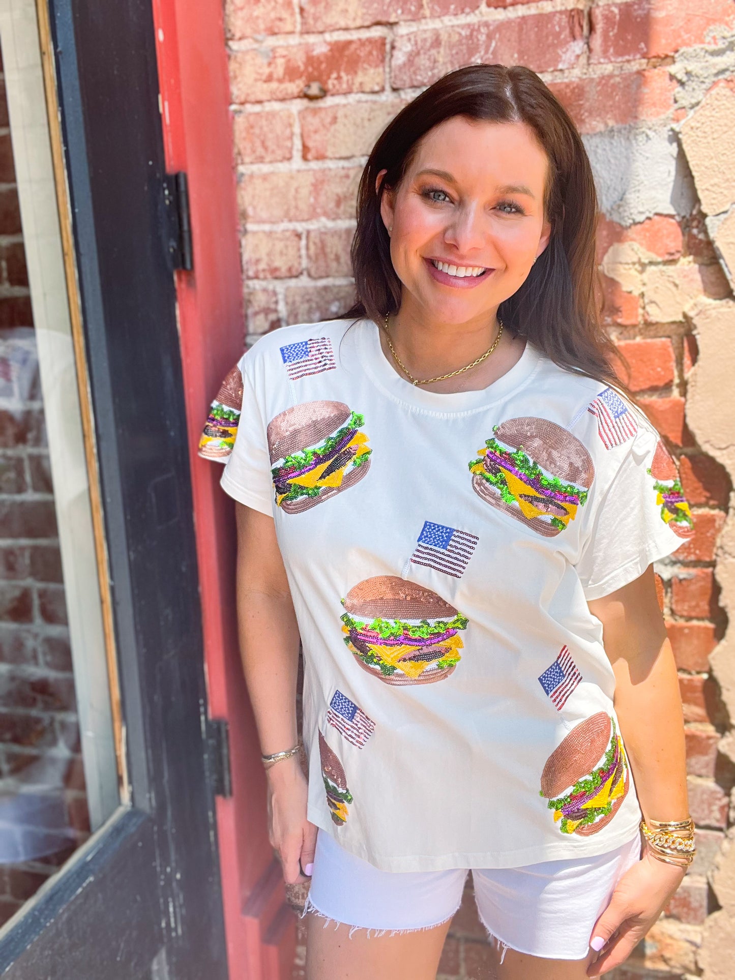 a woman standing in front of a brick building