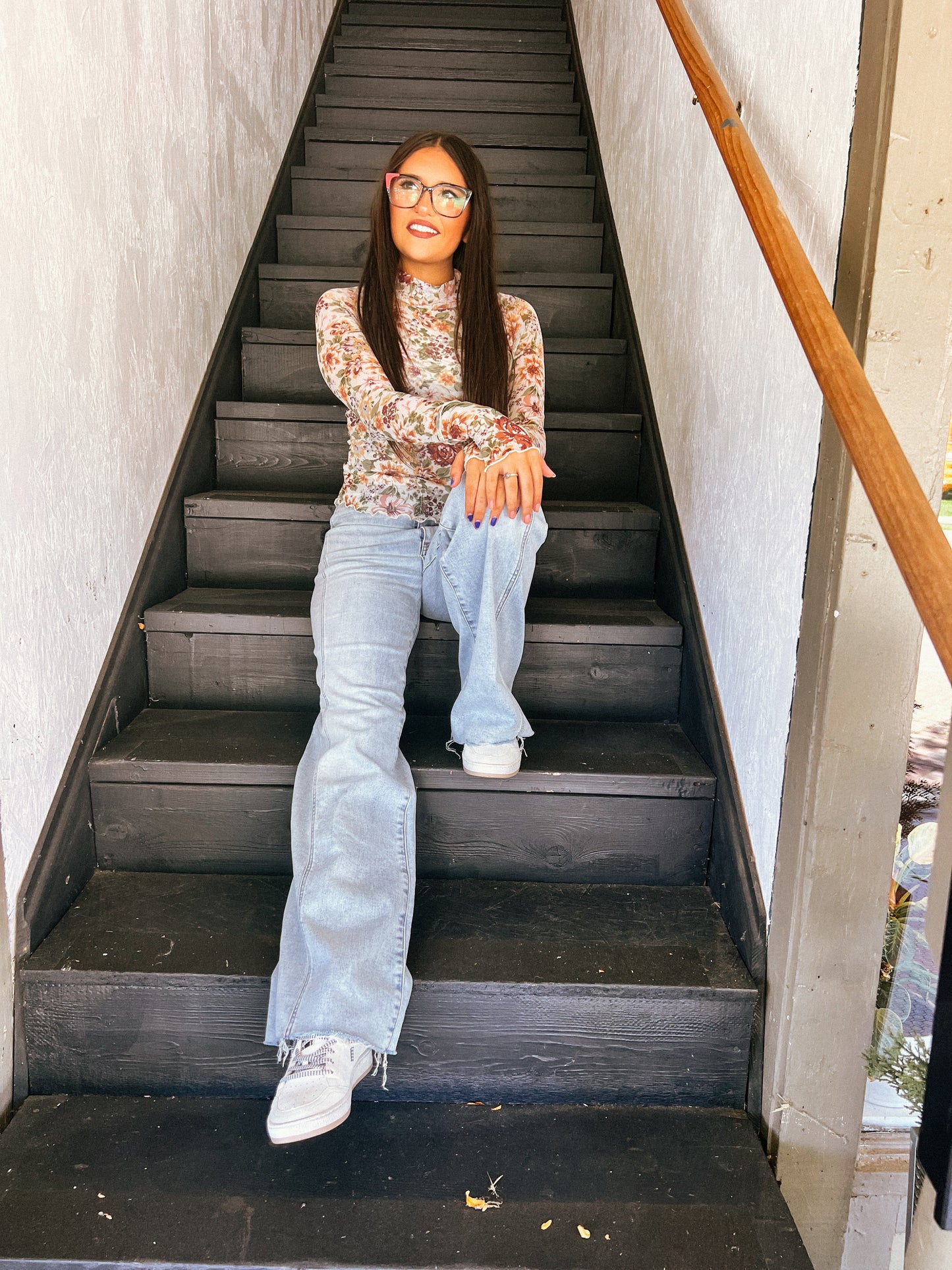 a woman sitting on the steps of a building