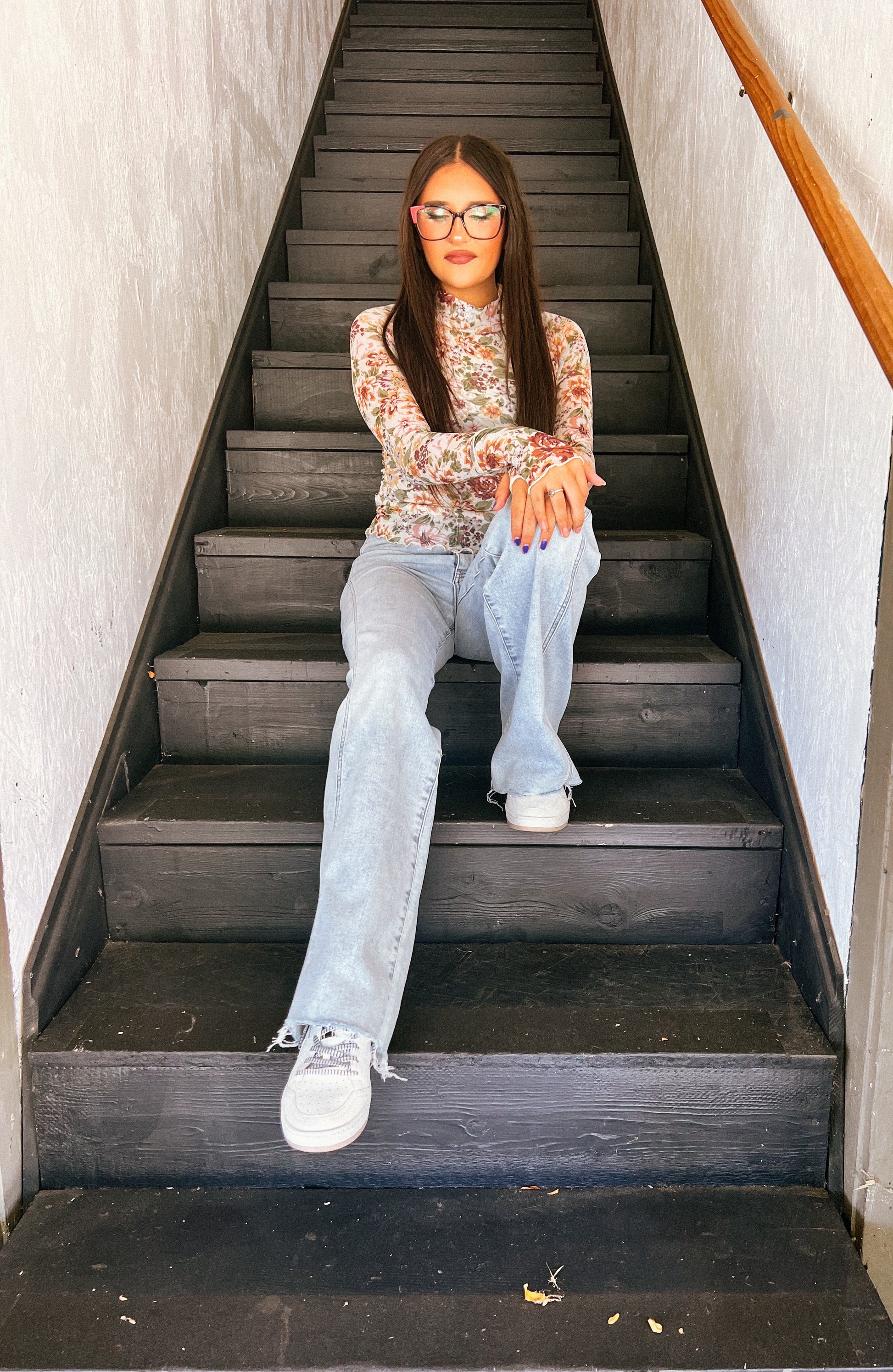 a woman sitting on a set of stairs