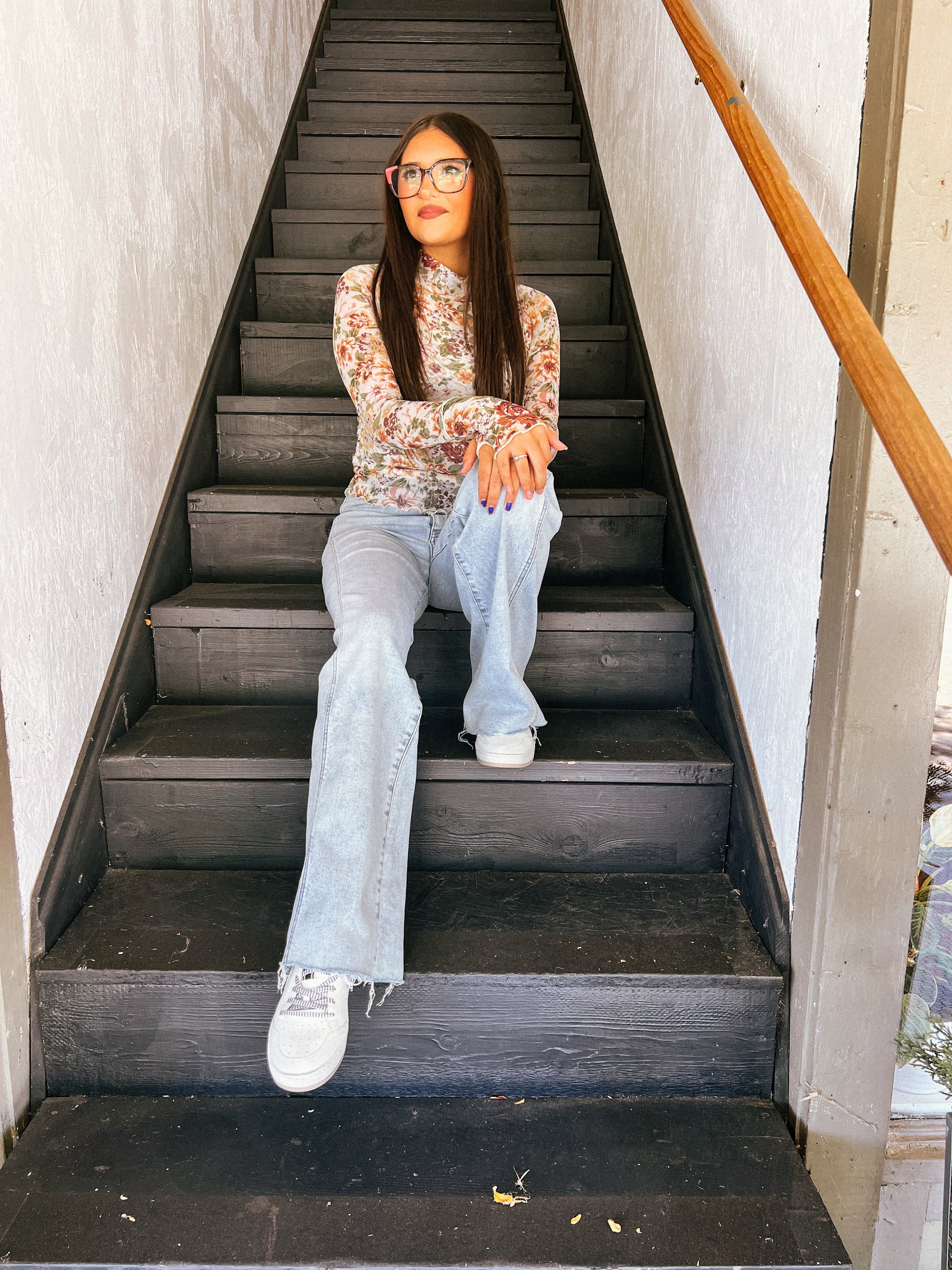 a woman sitting on a set of stairs