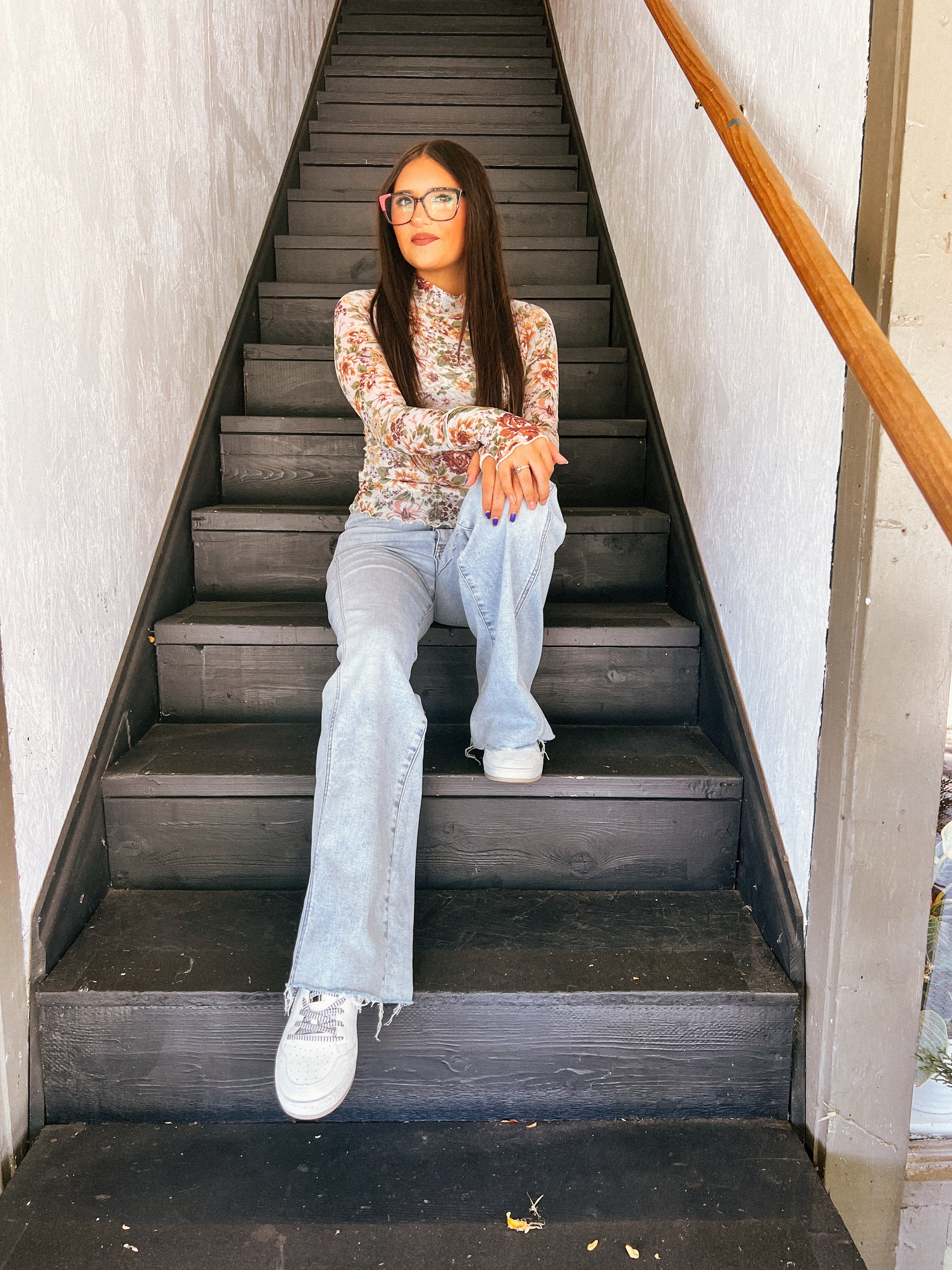 a woman sitting on a set of stairs