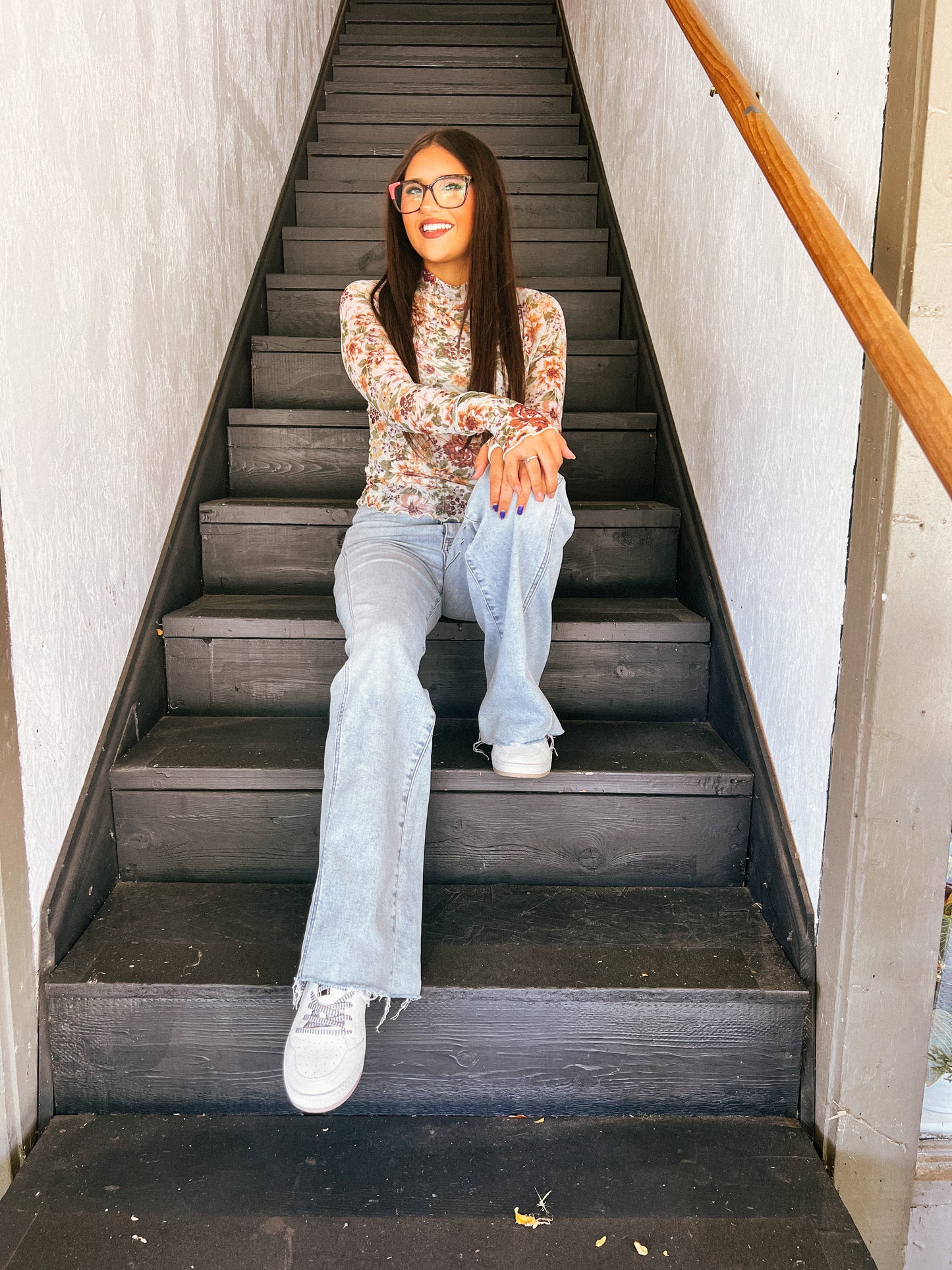 a woman sitting on the steps of a building