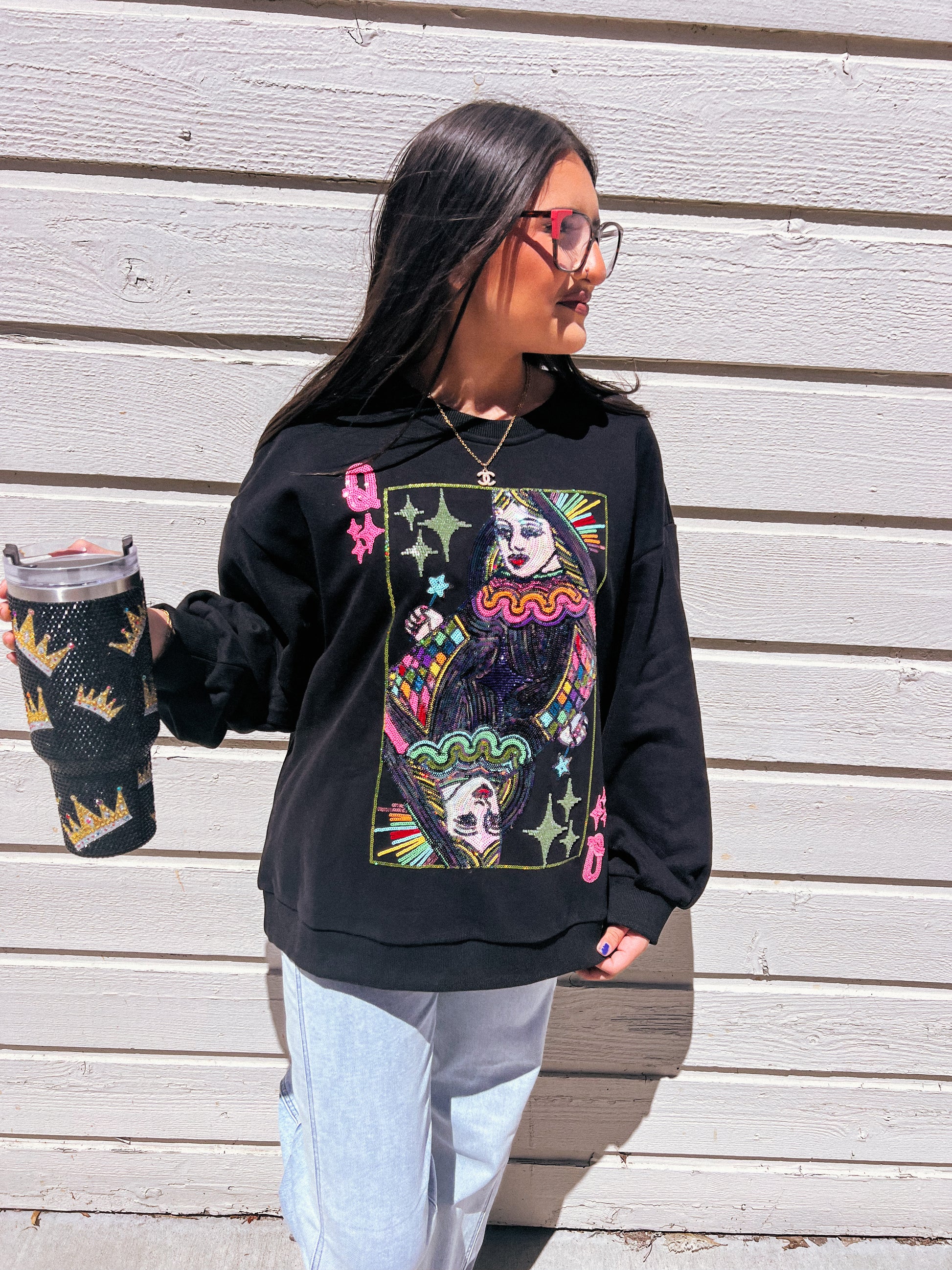 a woman wearing a black sweatshirt with a picture of a skeleton on it