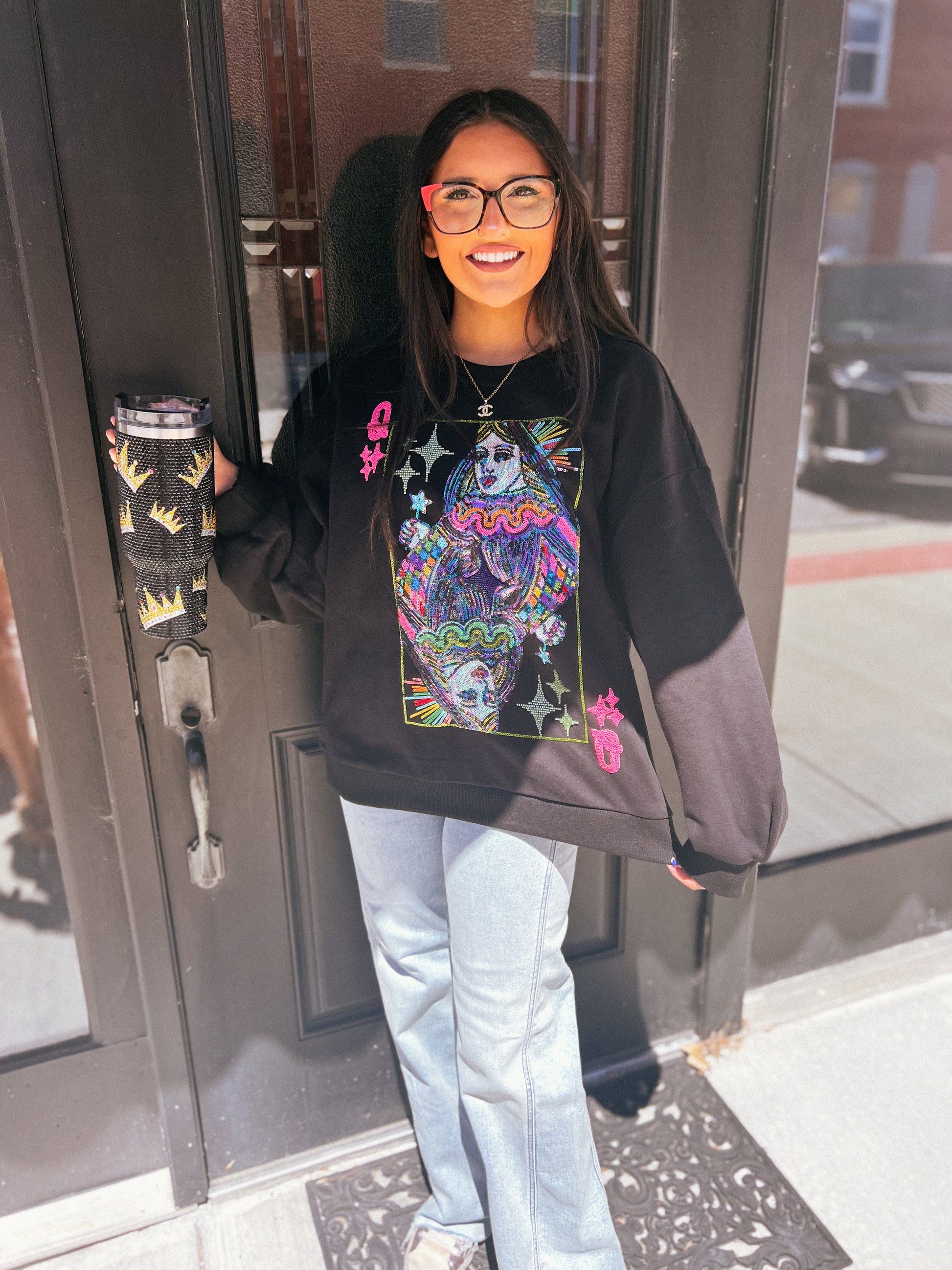 a girl with painted face standing in front of a door