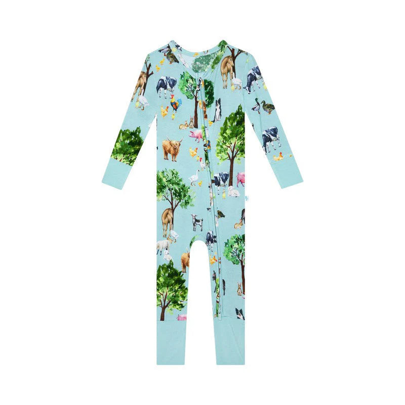 a baby's pajamas with animals and trees on it