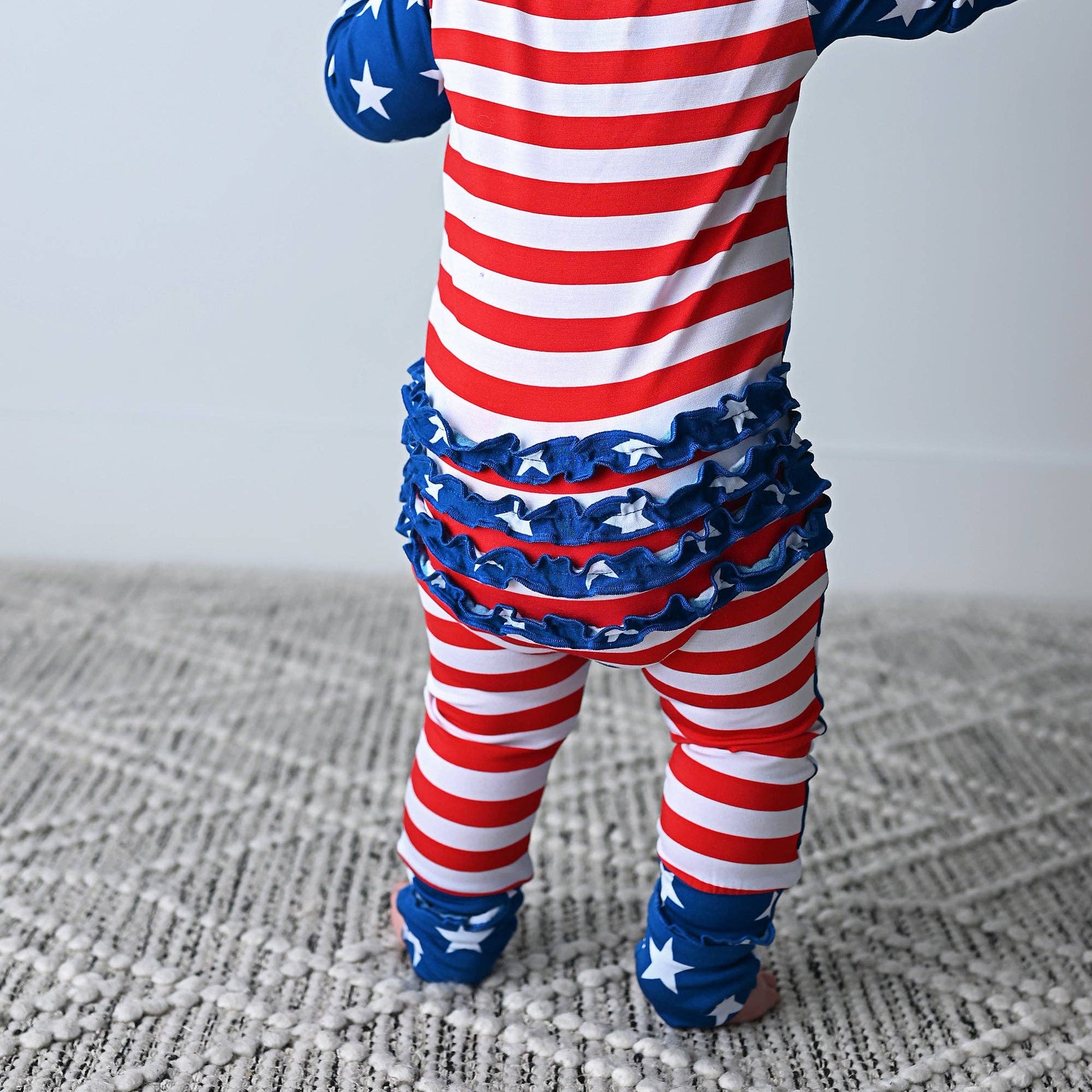 a baby in a red, white and blue outfit